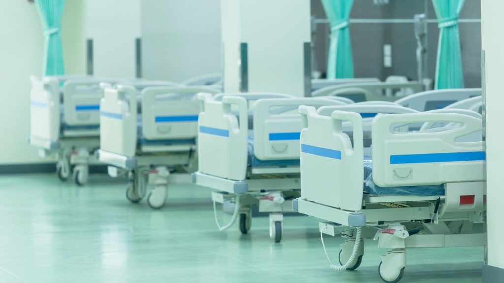 A row of empty hospital beds