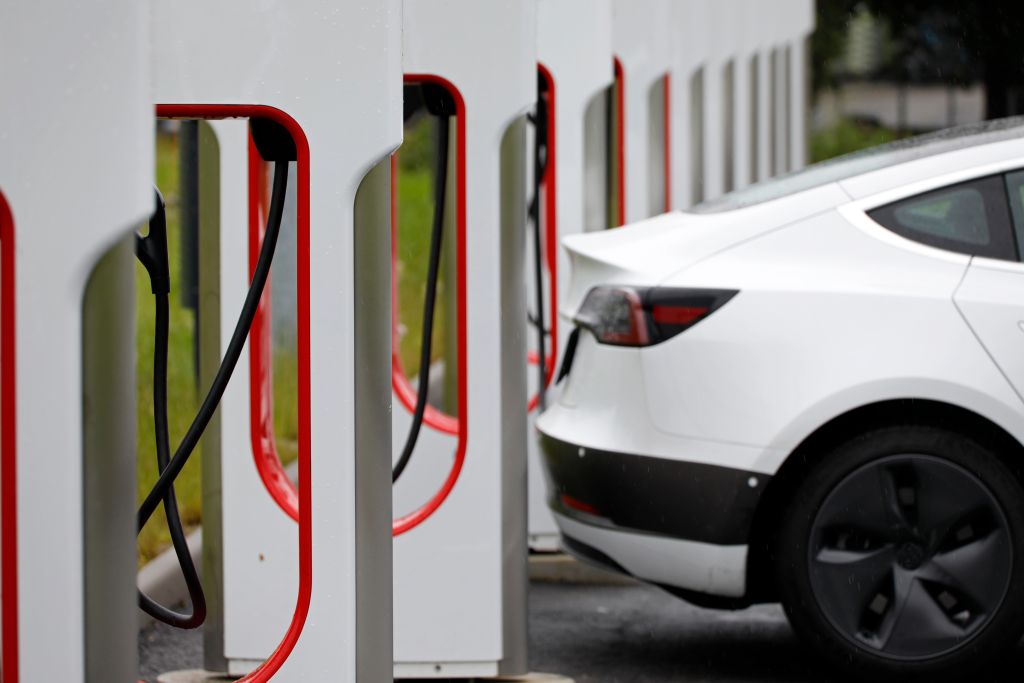 Electric car next to a row of charging stations.